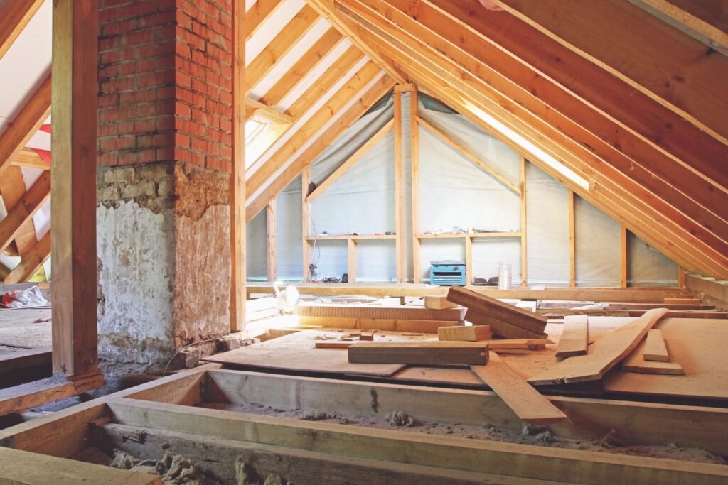 a room with a brick chimney and wood floor