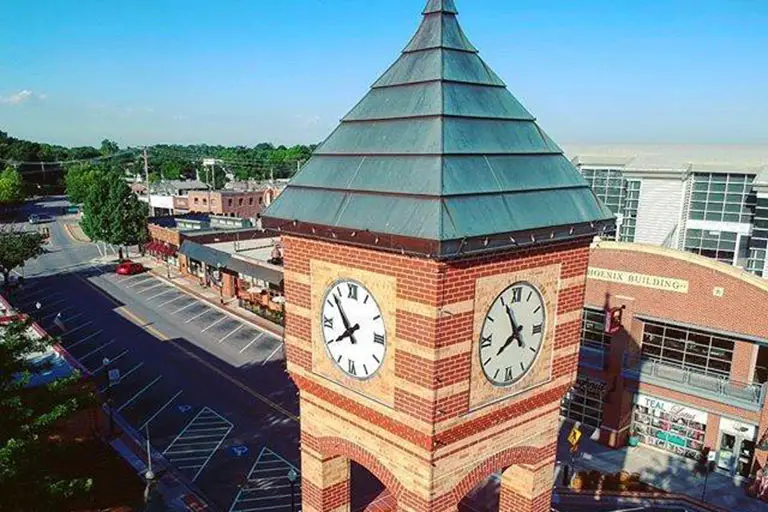 a clock tower with a pointy roof