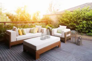 a patio with a white couch and a white table